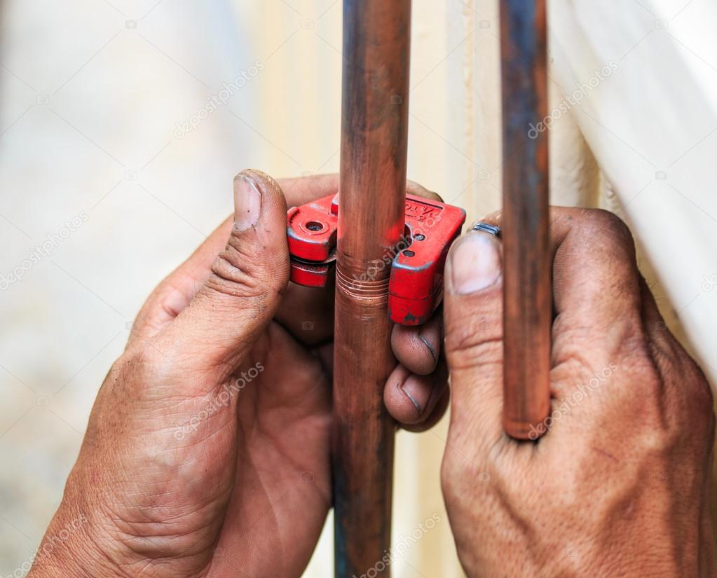 Repairman cut the copper pipe