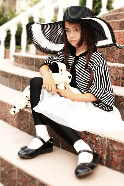 Little girl in a retro style with a soft toy — Stock Photo, Image