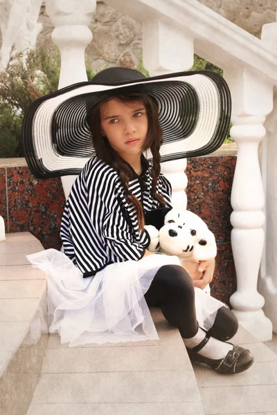 Little girl in a retro style with a soft toy — Stock Photo, Image