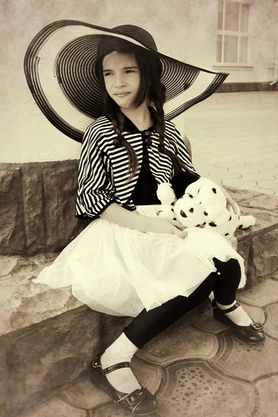 Little girl in a retro style with a soft toy — Stock Photo, Image