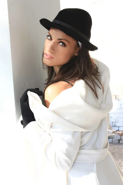 Girl with black hair in a white coat — Stock Photo, Image