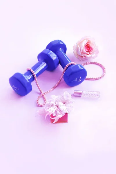 Dumbbell with a rose and a necklace of pearls on a pink background — Stock Image Dumbbell with a rose and a necklace of pearls on a pink background Royalty Free Stock Images