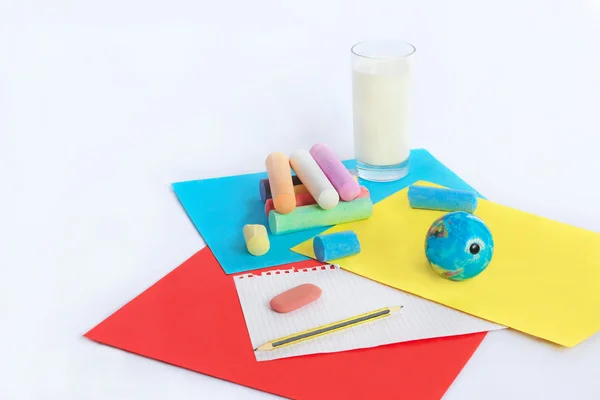 Glass of milk on the table with crayons and colored paper — Stock Photo, Image