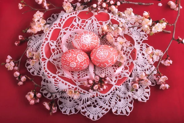 Easter eggs with ornaments and blossoming branch — Stock Photo, Image