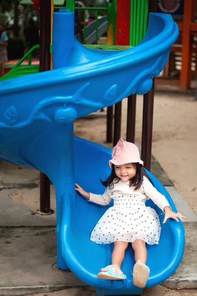 Girls with cute, white skinned Asians happily playing rides in the park.