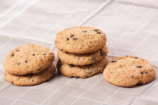Stacked chocolate chip cookies on brown napkin. — Stock Photo, Image