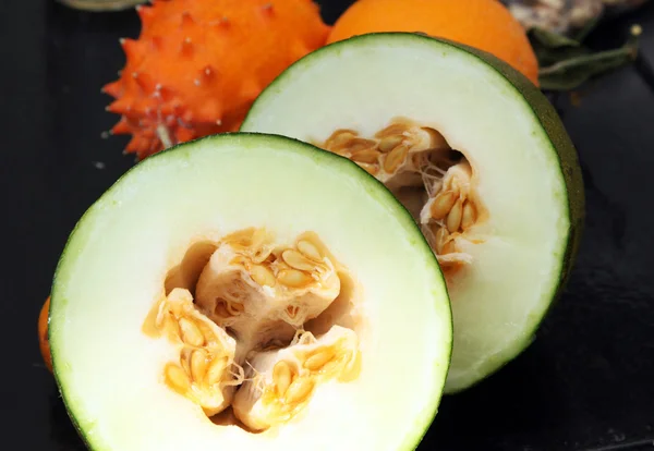 Exotic fruits: melon, kiwano and orange — Stock Photo, Image