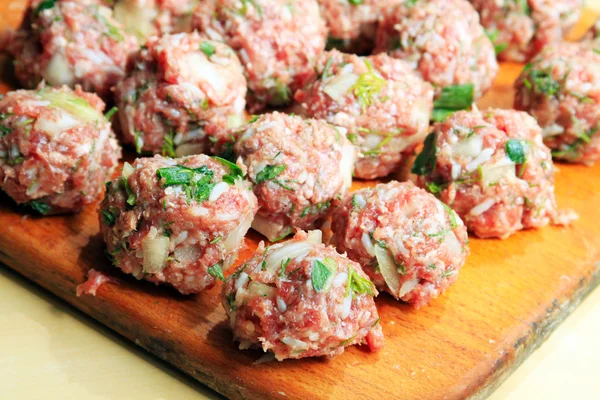 RAW köttbullar på en skärbräda — Stockfoto