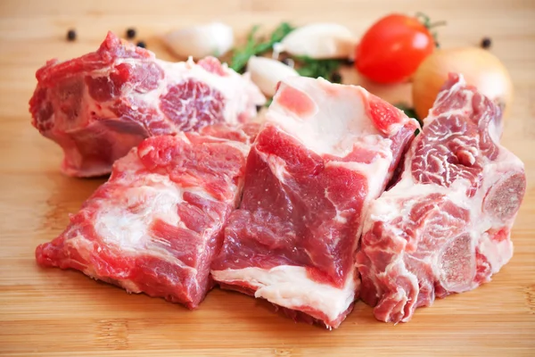 Raw beef with spices and vegetables on the cutting board — Stock Photo, Image