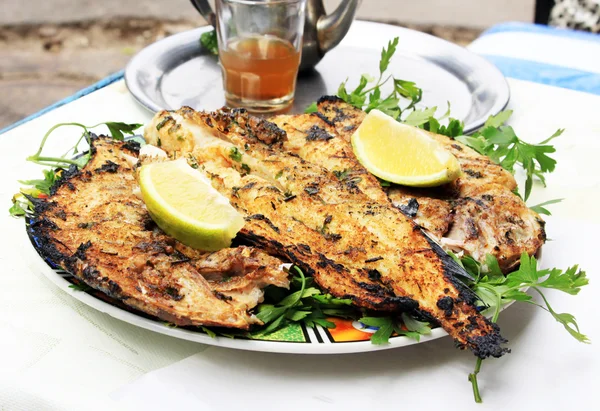 Grilled fish with greens on the plate — Stock Photo, Image