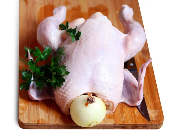 The whole chicken with parsley, onion and a knife — Stock Photo, Image