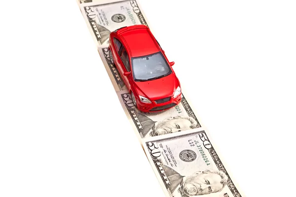 Red toy car on the money road, isolated on white — Stock Photo, Image