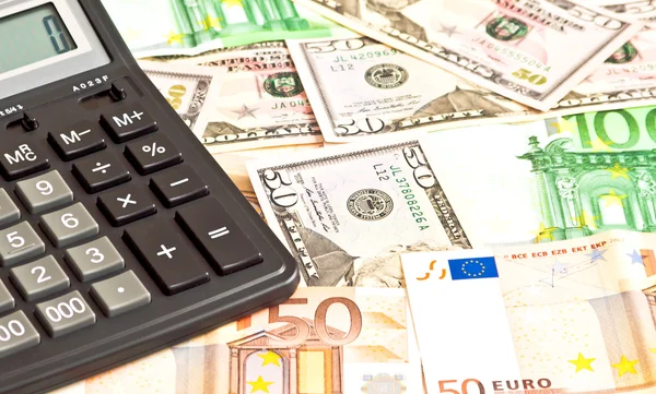Business picture with money (dollar and euro) and calculator Stock Image