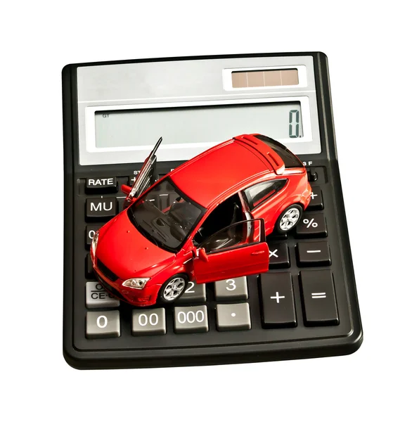 Іграшковий автомобіль і калькулятор над білим. Оренда, купівля, ремонт або страхування Ліцензійні Стокові Фото