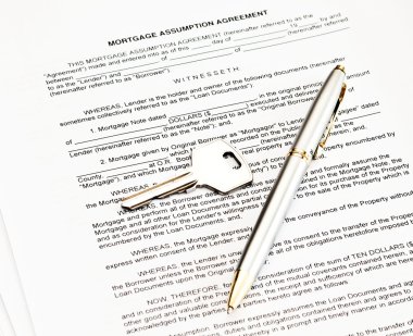 Mortgage assumption agreement with a pen for signature and a key clipart