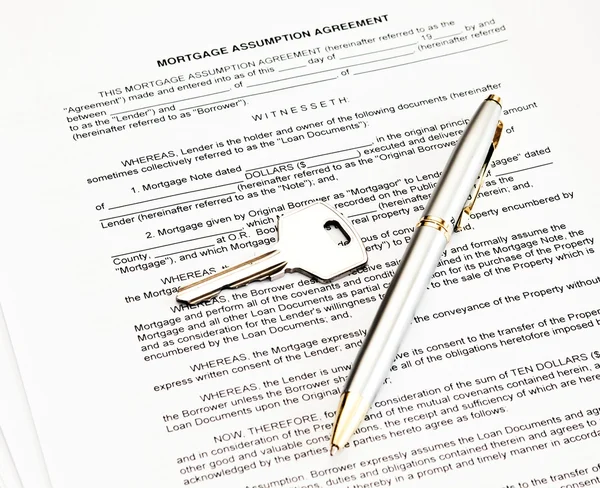 Veronderstelling hypotheekovereenkomst met een pen voor handtekening en sleutel — Stockfoto