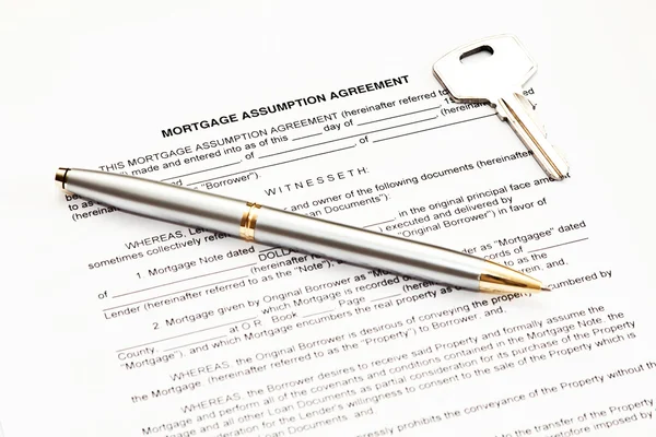 Mortgage assumption agreement with a pen for signature and a key — Stock Photo, Image