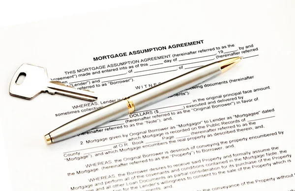 Mortgage assumption agreement with a pen for signature and a key — Stock Photo, Image