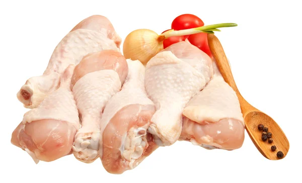 Raw chicken legs with vegetables, isolated on white background — Stock Photo, Image