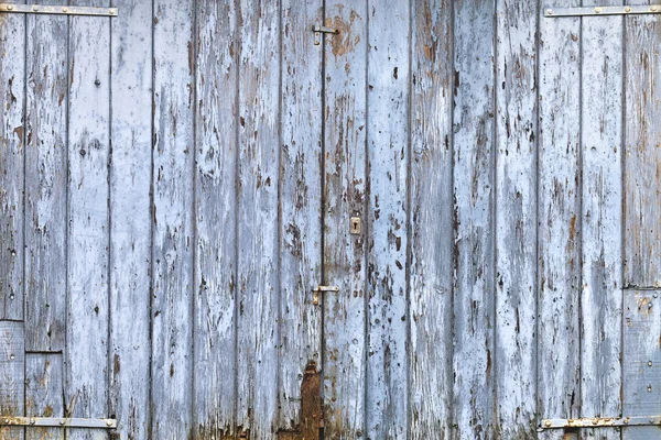 Old, grunge wood panels of wide light blue door — Stock Photo, Image