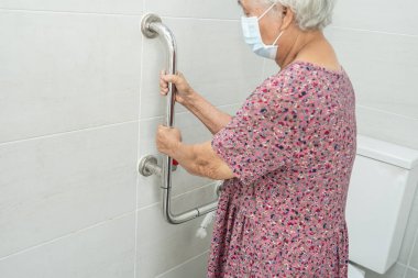 Asyalı yaşlı yaşlı kadın hasta, hemşire hastanesi koğuşunda tuvalet temizliği yapıyor. Sağlıklı güçlü tıbbi konsept..