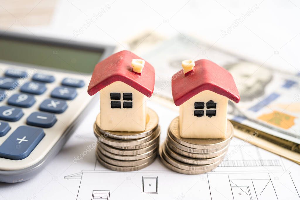 House with stack coins and uS dollar money on plan house, mortgage home loan finance concept.