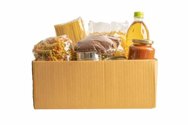 Foodstuff for donation, storage and delivery. Various food, pasta, cooking oil and canned food in box isolated on white background with clipping path.