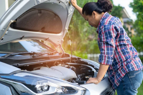 Open hood mechanic engine system to check and repair damage car crash.