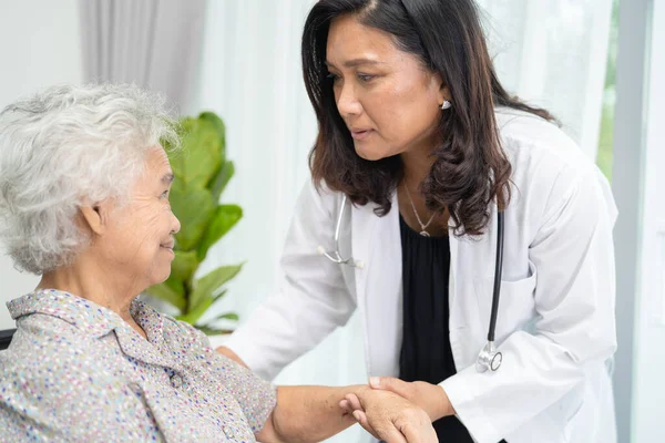 Doctor help and care Asian senior or elderly old lady woman patient sitting on wheelchair at nursing hospital ward, healthy strong medical concept