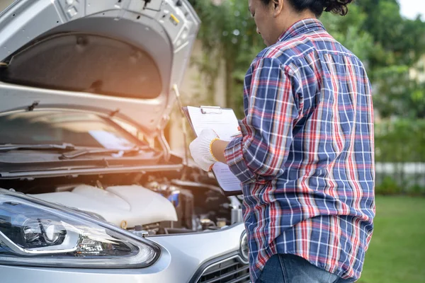 Open hood mechanic engine system to check and repair damage car crash.