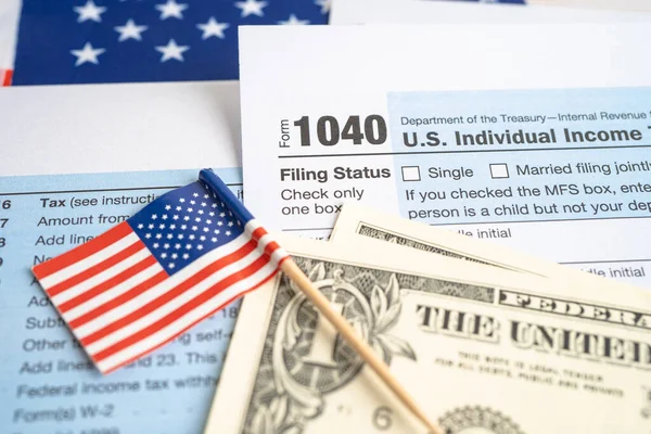 Tax Return form 1040 with USA America flag and dollar banknote, U.S. Individual Income.