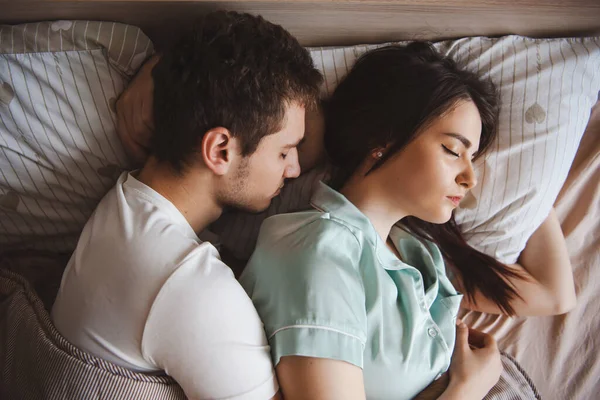 一对年轻夫妇睡在一起度过周末早晨的头像。情侣们 — 图库照片