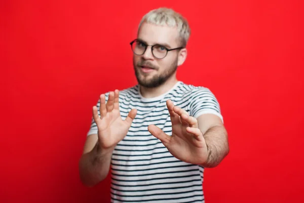 Homem vestindo óculos em pé sobre fundo vermelho afastando as mãos palmas das mãos mostrando sinal de recusa. Pare e proibido. — Fotografia de Stock