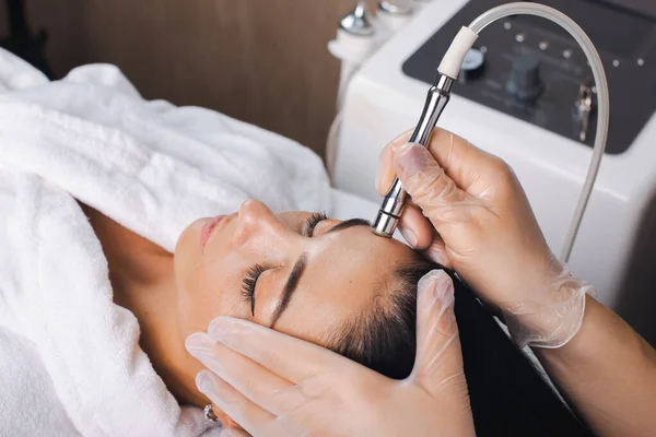 Cosmetologists hand is making cavitation rejuvenation skin treatment. Facial treatment. Facial skincare. Beauty skin care. Rejuvenation treatment.