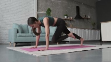 Video with a woman doing running plank on her fitness mat at home. Health lifestyle, fitness. Healthy lifestyle.