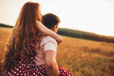 Arkaya bakan adam, Sonbahar Tepesi 'ndeki kız arkadaşını sırtında taşıyor. Dünyayı dolaşmak..