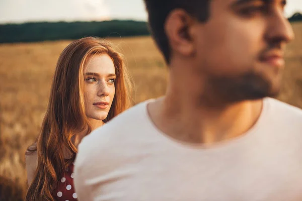 Retrato de una pareja caminando por el campo de trigo y explorando nuevos lugares. Retrato de cerca de un hombre y una mujer. — Foto de Stock