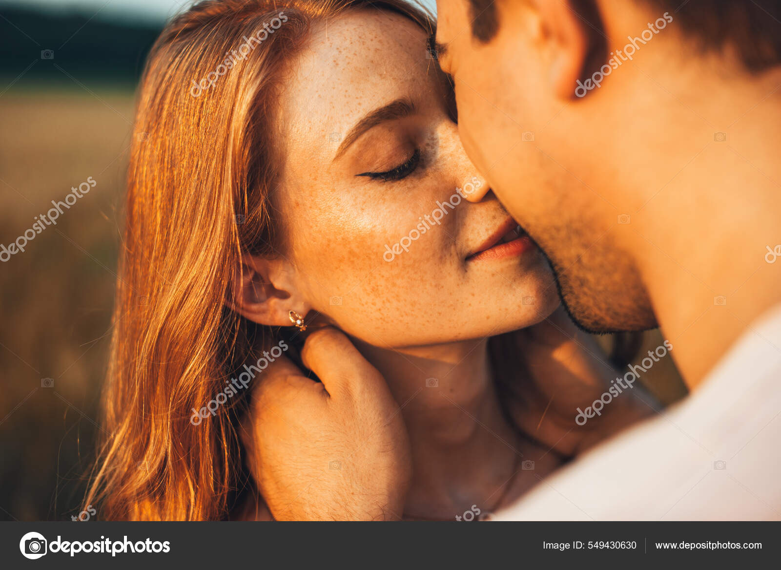 Close-up portrait of a freckled girl kissing her boyfriend while they are  on an outdoor date. Wheat field. People lifestyle concept. Stock Photo by  ©dekazigzag 549430630