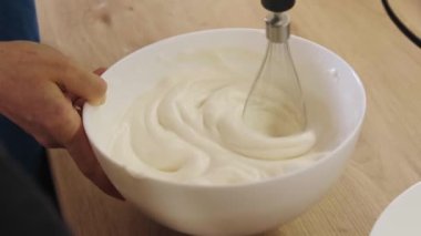 Kap kase tutan insanlar, pasta ve fırın için krema karıştırıyorlar. El ele tutuşarak. Portreyi kapat. Tatlı yemek..