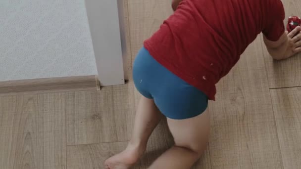 Baby sister imitating her brother, crawling on the floor playing with cars. Top view. Son, great design for any purposes. Happy family. — Stock Video