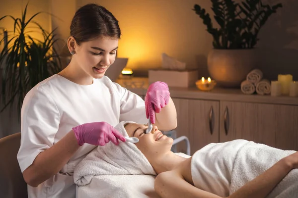 Caucasian woman getting beauty massage of her face at spa salon. Natural female beauty. Skin care. Facial treatment. Female beauty portrait. Body care.