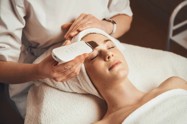 白种人妇女接受超声波洗涤器清洁皮肤的面部程序 面部治疗 护肤美丽的皮肤 — 图库照片