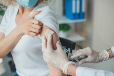 Doctor in medical gloves giving antivirus vaccine shot to a patient. Coronavirus prevention. Vaccination concept.