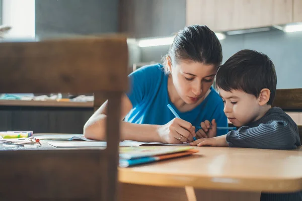 Mother Helping Her Son Homework Home Writing Education Concept Love — Fotografia de Stock