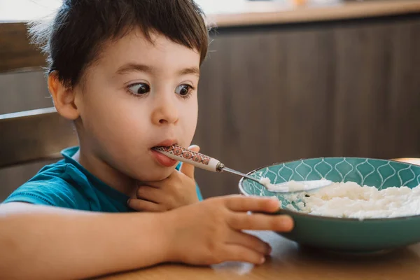 Boy Who Has Finished Eating Porridge Caress Holding Spoon His — стоковое фото