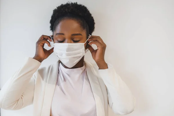 Black Woman Putting Face Covid Mask Isolated White Wall Covid — Stok Foto