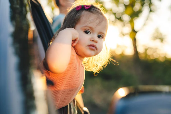 Baby Girl Peeking Out Car Window Smiling While Looking Camera — Fotografia de Stock