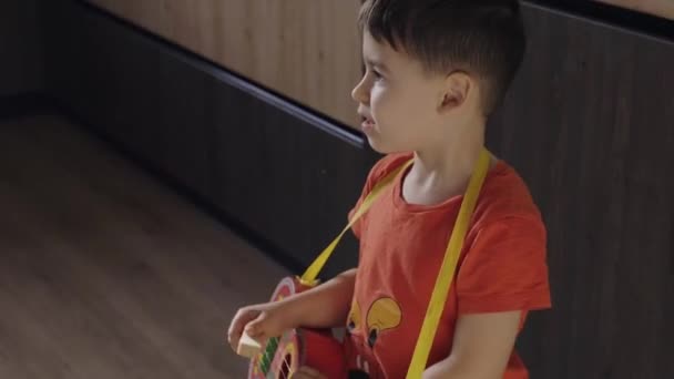 Happy Little Boy Having Fun Playing Ukulele Home Preschool Boy — Wideo stockowe