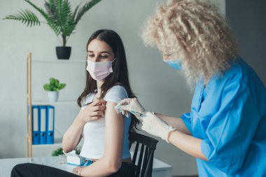 Nurse giving to a patient an injection at a hospital. Virus, epidemic, disease. Virus epidemic outbreak. Medicine medical health. Coronavirus vaccination.
