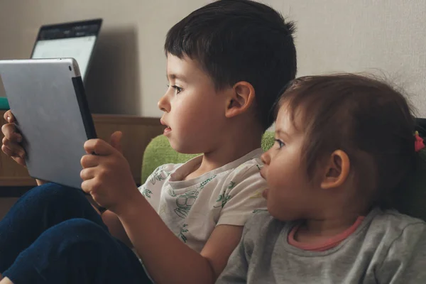 Two Little Kids Playing Games Computer Tablet Together Sitting Sofa — 스톡 사진